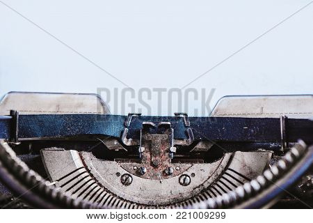 Modern typewriter with sheets of paper on a dark background. Editing and copywriting workplace. Creative writing concept.