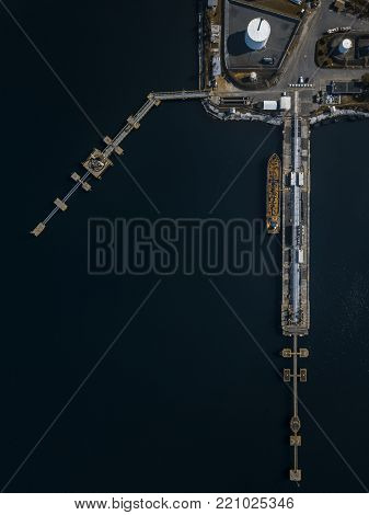drone view of a ship docking next to the pear in the port