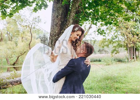 caucasian happy romantic young couple celebrating their marriage . Bride and groom in park