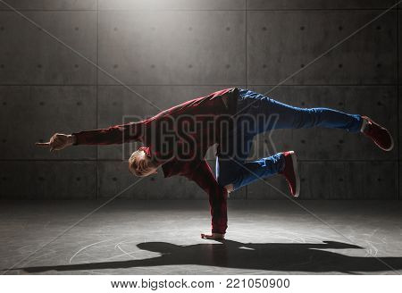 Young stylish male breakdancer posing in studio
