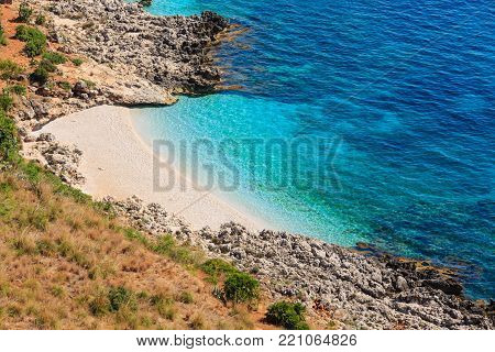 Paradise sea bay with azure water and beach view from coastline trail of Zingaro Nature Reserve Park, between San Vito lo Capo and Scopello, Trapani province, Sicily, Italy