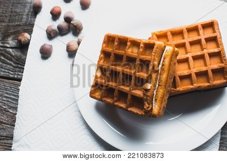 Waffle On A Wooden Background On A White Napkin