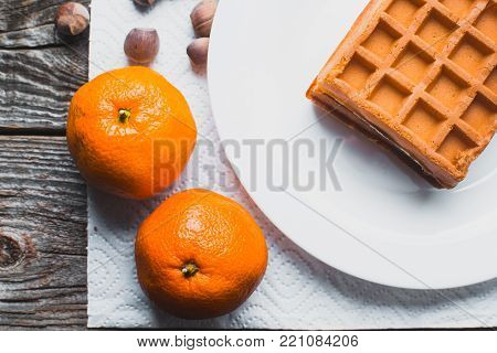 Waffle On A Wooden Background On A White Napkin