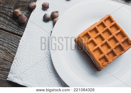 Waffle On A Wooden Background On A White Napkin