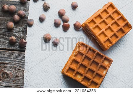 Waffle On A Wooden Background On A White Napkin