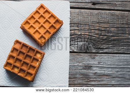 Waffle On A Wooden Background On A White Napkin