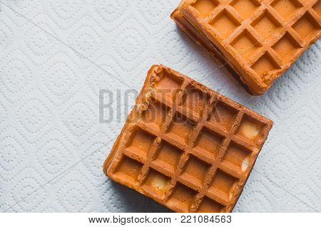 Waffle On A Wooden Background On A White Napkin