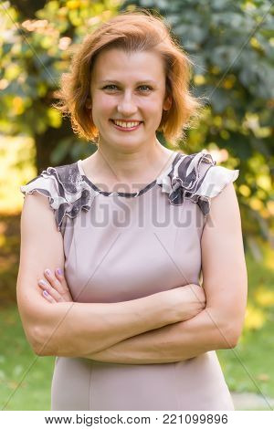 Portrait of Attractive Smiling Caucasian Ethnicity Young Woman in the park