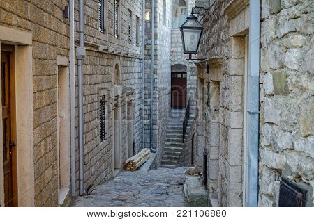 Old narrow street in Stari Grad of Ulcinj, Montenegro. The fortress in the Old town in a sunny summer day.