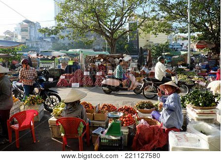 HO CHI MINH CITY, VIET NAM- NOV 21, 2017: Amazing scene of fruits market at Cho Lon, Vietnam in early morning, colorful fruit basket show at open air market, crowded and busy street