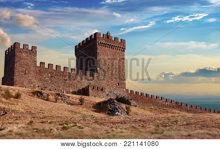 An old Genoese fortress in Sudak on the Black Sea coast in the Crimea. Sunny evening. Panorama.