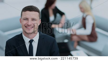 Portrait of business man  looking at camera on the background of