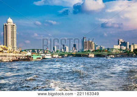 Business district cityscape from Chao Phraya River in Bangkok Thailand.
