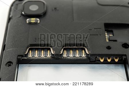 Slot for dual SIM cards and sd card, on a cell phone, mobile phone, smartphone close-up macro detail, isolated over white background