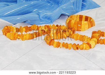 Amber necklace on a light blue background, jewelry made of natural amber