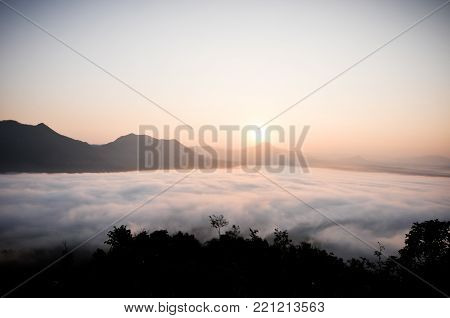 Early morning foggy sunrise on top of mountain soft focus.
