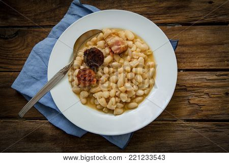 fabada is a typhical spanish legumes dish with big beans and sausage