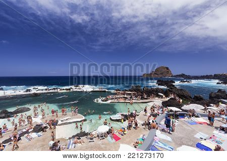 Porto Moniz, Portugal - August 7: Unidentified People Swim In The Piscinas Naturais Or Natural Ocean
