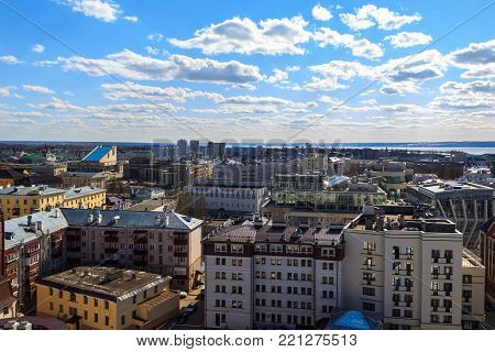 Russia, Kazan - April 26, 2017: View from above on Vakhitovsky and Privolzhsky districts, shopping centers, buildings, hotels, mosques and churches. In background Volga River, river port and the elevator