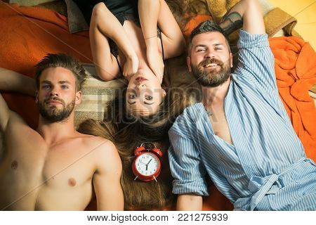 people lovers sleep at alarm clock, time. Swinger relations, relax, wake up. Family trust, polygamy, betrayal. men and woman with long hair, lover. Love triangle and romance, perfect morning. friends