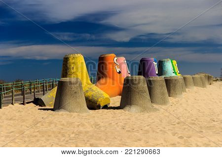 Colorful pylons standing at Silvalde's beach in a warm morning