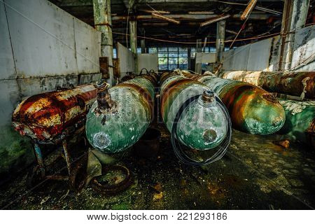 Old rusted submarine torpedoes in abandoned torpedo factory.