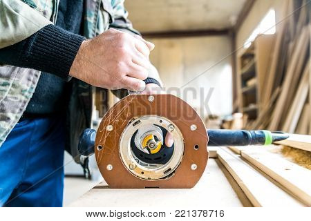 Closeup woodeworking rooter in hands of carpenter