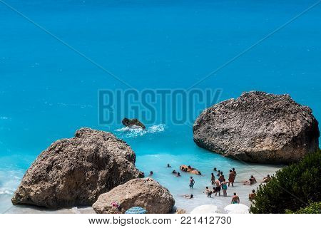 People Swim In The Sea At The Megali Petra Beach In Lefkada Island, Greece
