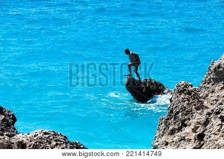 People Swim In The Sea At The Megali Petra Beach In Lefkada Island, Greece