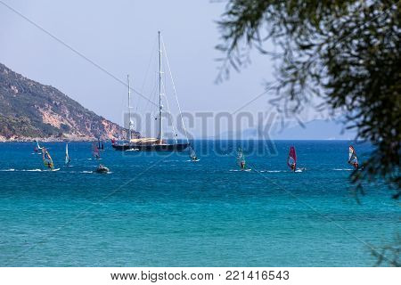 People Swim In The Sea At The Megali Petra Beach In Lefkada Island, Greece