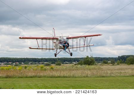 Zhitomir, Ukraine - July 31, 2011: Antonov An-2 biplane islanding on an airstrip in cloudy weather conditions