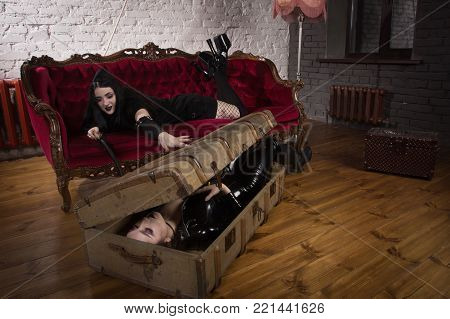 The Woman In Uniform Strangles The Second Woman With A Chain From The Handcuffs