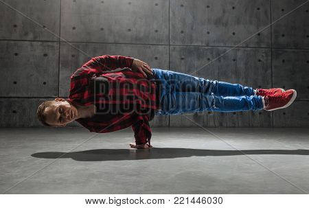 Young stylish male breakdancer posing in studio