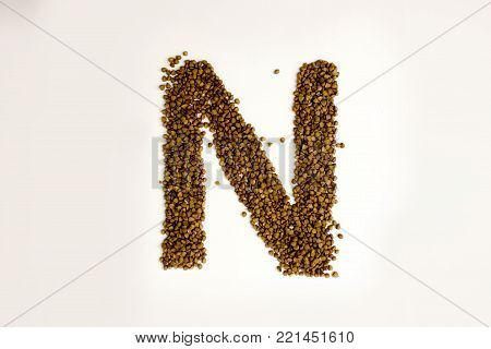 n letter. the alphabet of buckwheat porridge. buckwheat grain. concept of healthy eating. photo for your design. horizontal sheet orientation