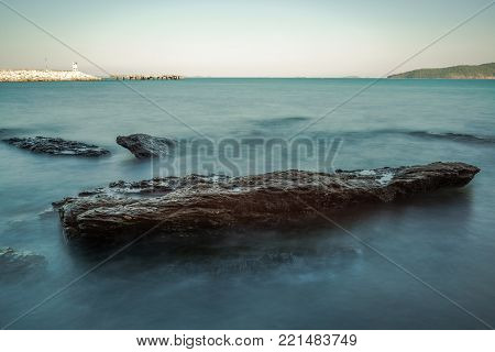Sea wave impact with rock streak like a boil water with clear sky, Khao Leam Ya National Park at Rayong of Thailand (Long Exposure Technique photograph)