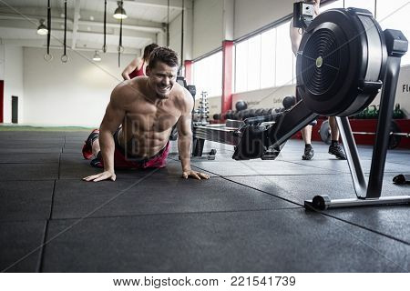 Determined Man Practicing Pushups In Gym
