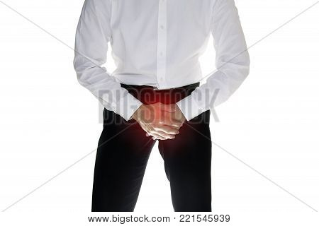 Man is suffering and holding his genitals isolated on white background with clipping path