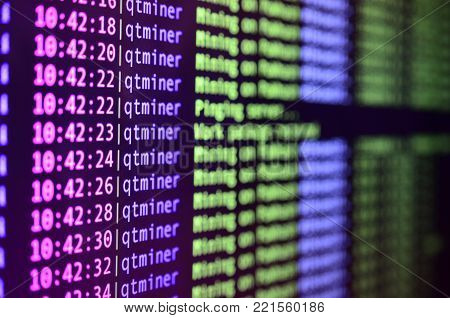 Macro snapshot of the program interface for crypto currency mining on the monitor of an office computer. The concept of mining bitcoins. The flow of information strings and data
