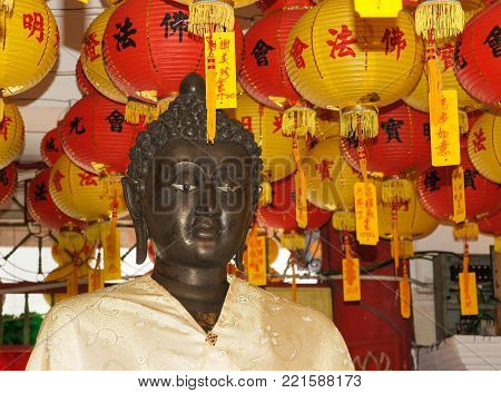 PENANG, MALAYSIA - JANUARY 28, 2011: Statue of Buddha under Chinese lanterns within the Buddhist temple Kek-Lok-Si close to Georgetown on January 28, 2011 in Air Hitam, Penang, Malaysia, Asia