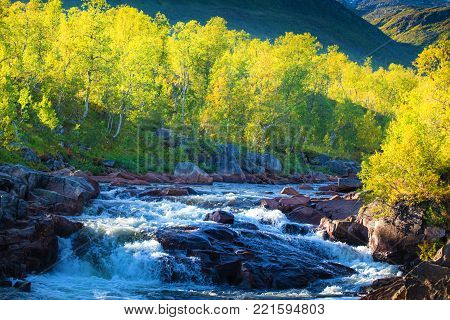 Mountain stream at the sunset. Spring north landscape. Nature of Norway, Senja island.