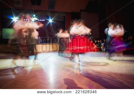 Classical blurred dancers in motion in a ballroom