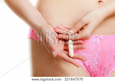 Women hygiene protection concept. Part body woman with tampon. Girl in lacy lingerie on time of menstruation monthly cycle.