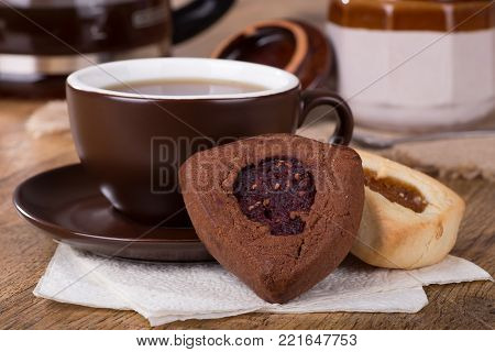 Raspberry and apricot filled hamantash cookies and cup of coffee