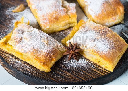 Apple strudel pie puff pastry. Traditional Austrian strudel with apple spices and sugar powder. Close up.