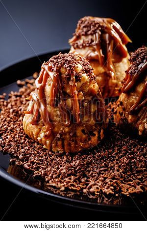 Chocolate creamy brownies with chocolate chips on dark background