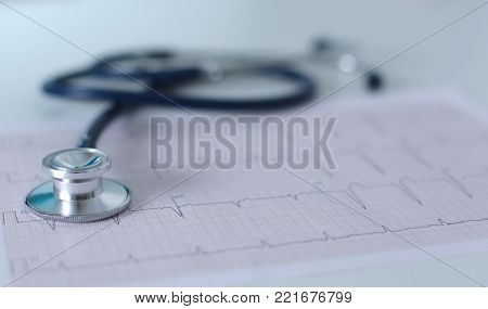 docter workplace with a stethoscope Cardiogram chart with medical table closeup, for heart record.