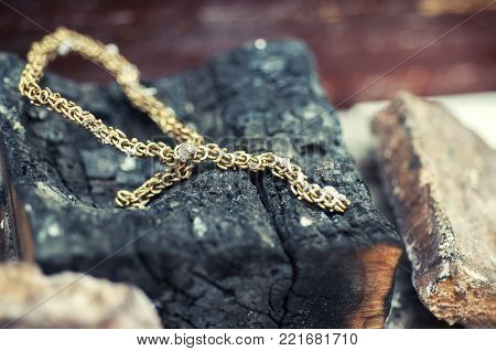 Craft jewelery making with professional tools. Gold chain repairing. Macro shot. Different stages of the manufacturing process of jewelry chain. Red-hot chain. Selective focus.