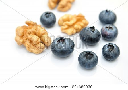 Blackberies and walnuts isolated on white background.