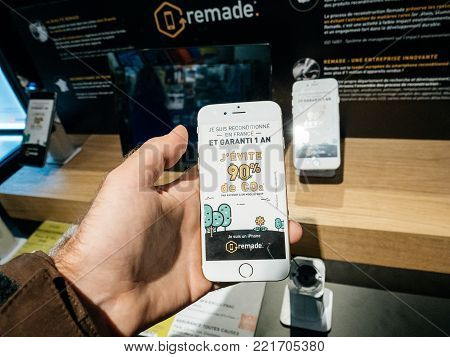 PARIS, FRANCE - NOV 23, 2017: Black Friday store shopping day in France, Paris with customers buying electronics gadget in Fnac retail chain - refurbished Apple iPhone in male hands