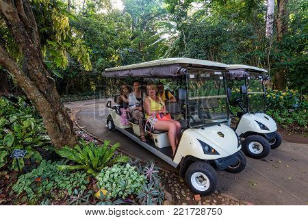 PERADENIA, SRI LANKA -CIRCA DECEMBER 2016: Happy tourists on cart in Royal Botanical Garden, the largest of the botanical gardens of Sri Lanka.